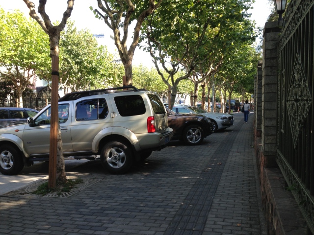 This is the sidewalk in front of the boys' school. Every day after school drivers bounce their cars up on the sidewalk like this to wait for the students in the Chinese school next door to our school. 